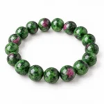 Natural Ruby Zoisite Crystal Bracelet for men and women featuring green Zoisite gemstone beads with reddish-pink Ruby inclusions and natural dark patterns, available in 8mm and 10mm round beads.