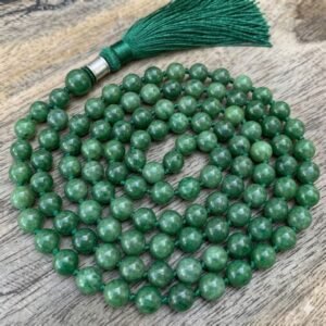 Green jade mala necklace featuring polished round beads and a tassel, traditionally used for meditation and spiritual practices.