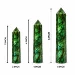 Labradorite crystal pencil tower in 3, 4, and 5 inch sizes with a natural green-blue flash, shown in hand for size reference