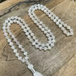 Selenite mala with luminous white beads and a soft tassel, designed for meditation and spiritual cleansing.