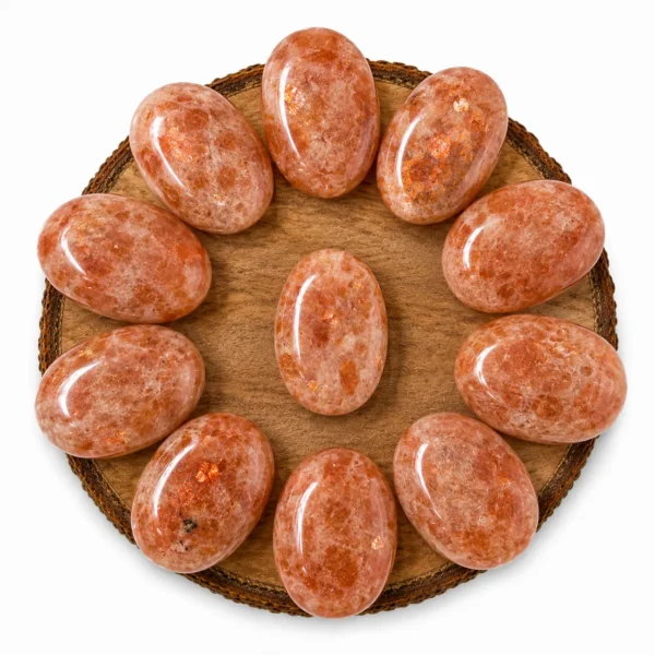 Natural sunstone palm stone with warm peach colour and natural sparkling inclusions