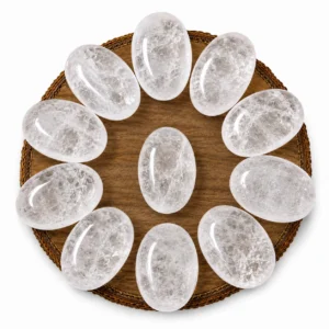Natural clear quartz palm stone with translucent appearance and smooth polished surface