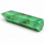 Natural green chrysoprase crystal obelisk pencil tower displayed on a white background with polished pointed tip and natural matrix