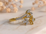 Gold flower and leaf diamond cocktail ring with elegant floral design and sparkling diamond accents