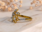 Gold flower and leaf diamond cocktail ring with elegant floral design and sparkling diamond accents