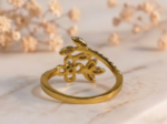Gold flower and leaf diamond cocktail ring with elegant floral design and sparkling diamond accents