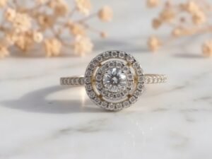 Celestial Swirl Double Halo Round Diamond Ring featuring a round center diamond with a swirling double halo design.