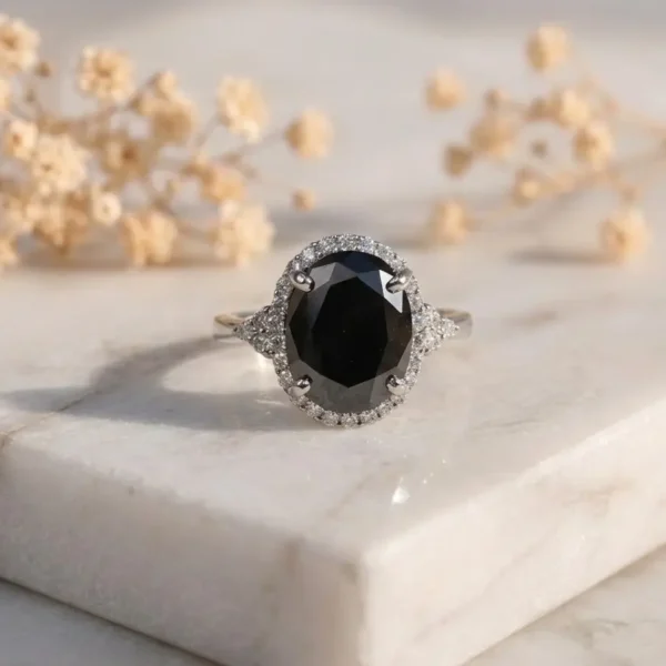 Oval Black Moissanite Halo Ring featuring an oval black moissanite center stone surrounded by a sparkling halo.