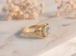 Radiant halo bloom lab grown diamond engagement ring with oval center stone and triple-row gold pavé band.