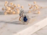 Blue Sapphire Floral Halo Diamond Ring featuring a blue sapphire center stone surrounded by a floral diamond halo.