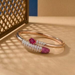 A rose gold bypass bangle featuring two emerald-cut amethyst stones and intricate geometric filigree.
