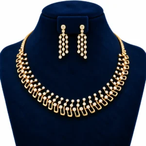 Geometric lab grown diamond necklace set in yellow gold with matching round diamond drop earrings displayed on a navy blue jewellery stand