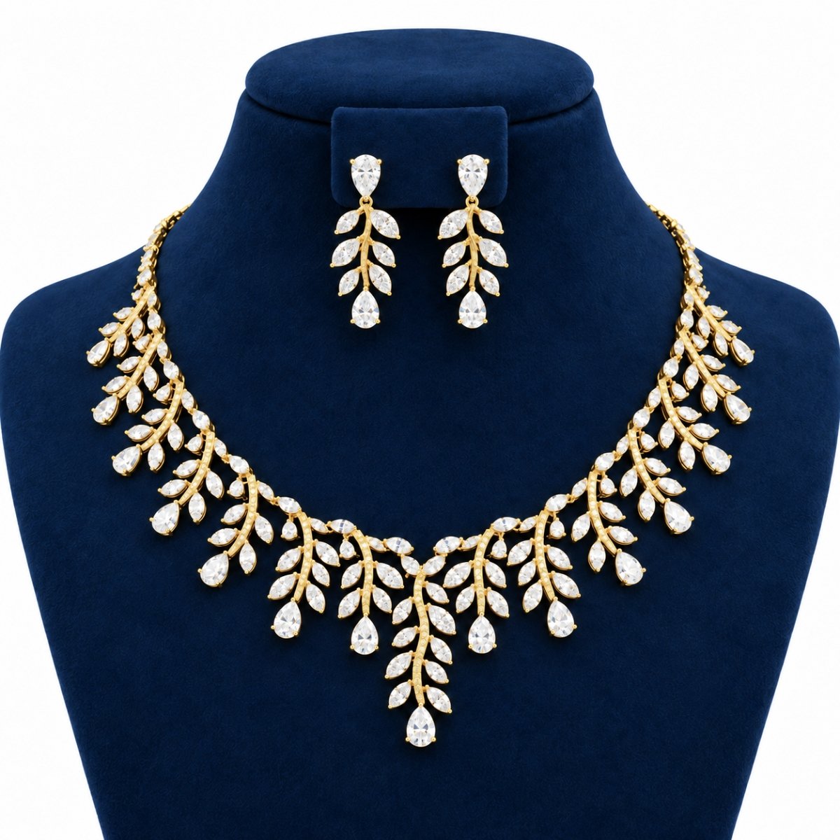 18K Gold Pear Cut Lab Grown Diamond Floral Necklace Set with Earrings (7) Pear cut floral lab grown diamond bridal necklace set with matching leaf design drop earrings displayed on navy blue jewellery bust
