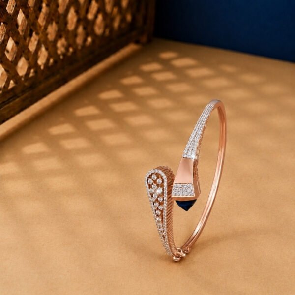 A yellow gold hinged bangle featuring seven graduated oval stations set with pavé diamonds on a neutral background.