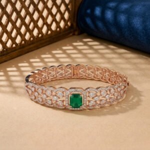 A rose gold ribbed bangle featuring alternating vertical rows of pink stones and white lab diamonds on a neutral background.