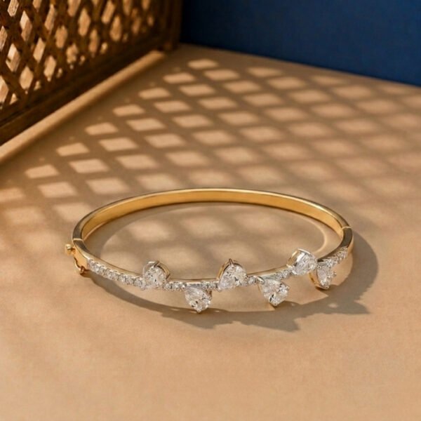 A handcrafted diamond vine bracelet with pear-cut diamonds in a yellow gold setting.