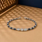 Art Deco style lab-grown diamond and blue sapphire bracelet in white gold setting.