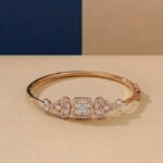 A handcrafted diamond vine bracelet with a central square halo in rose gold.
