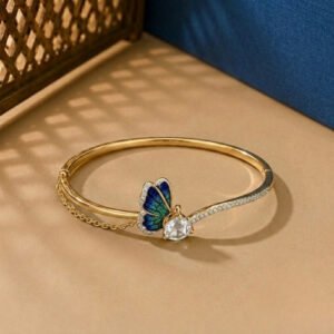 A handcrafted diamond vine bracelet featuring blue sapphires and multi-shape diamonds in a white gold setting.