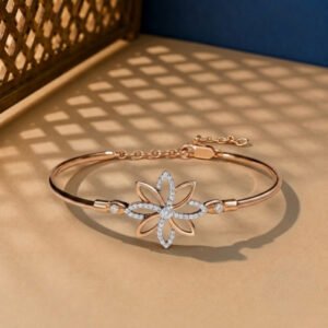 A handcrafted diamond vine bracelet with a blue enamel butterfly and safety chain in yellow gold.