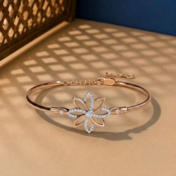 A handcrafted diamond vine bracelet with a blue enamel butterfly and safety chain in yellow gold.