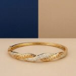A handcrafted yellow gold diamond vine bracelet featuring a woven lattice pattern and pavé diamonds.