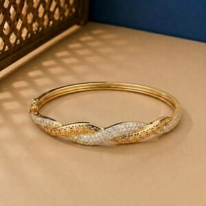 A handcrafted yellow gold diamond vine bracelet featuring a woven lattice pattern and pavé diamonds.