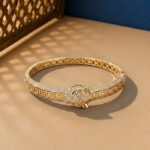 A yellow gold imperial panther bracelet with Greek Key engravings and diamond pavé.
