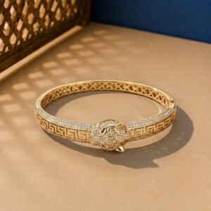 A yellow gold imperial panther bracelet with Greek Key engravings and diamond pavé.