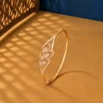 A yellow gold diamond vine bracelet featuring a symmetrical bypass leaf design with pavé lab-grown diamonds on a neutral background.
