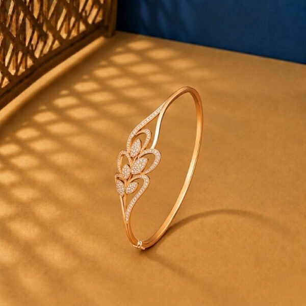 A yellow gold diamond vine bracelet featuring a symmetrical bypass leaf design with pavé lab-grown diamonds on a neutral background.