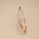 A rose gold diamond vine bracelet featuring a triple-strand stem and five marquise-shaped diamond clusters on a neutral background