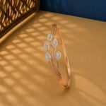 A rose gold diamond vine bracelet featuring a triple-strand stem and five marquise-shaped diamond clusters on a neutral background.