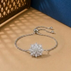 A white gold diamond vine bracelet featuring a central marquise-cut diamond flower on an adjustable box chain.