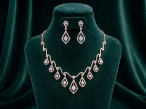 Modern angular drop necklace and earring set featuring sharp geometric diamond accents on a luxury velvet display.