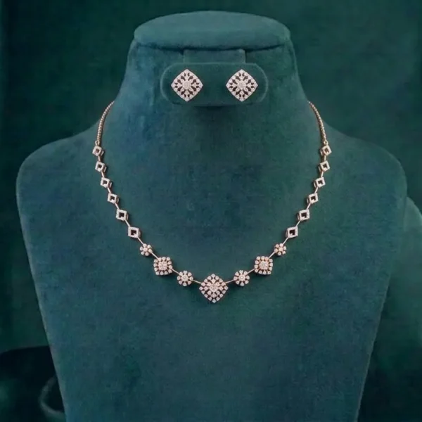 Minimalist geometric jewelry set featuring interlocking diamond clusters on a soft satin fabric.