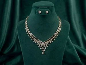 : Graceful diamond leaf drop necklace and earring set featuring marquise-cut stones on a luxury velvet display.