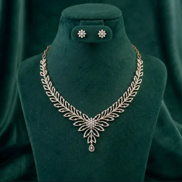 : Graceful diamond leaf drop necklace and earring set featuring marquise-cut stones on a luxury velvet display.