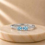 Double Pear Blue Topaz Pavé White Gold Ring featuring two pear-shaped blue topaz gemstones accented with sparkling pavé-set diamonds in elegant white gold.