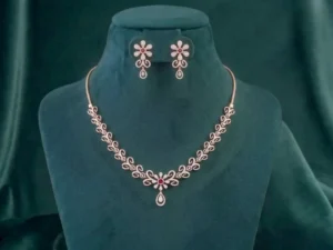 Sophisticated floral diamond necklace and matching earrings featuring intricate petal motifs on a smooth satin display.