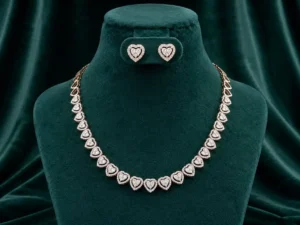 Romantic heart-link necklace and earring set featuring pavé-set diamond accents on a luxury velvet display.