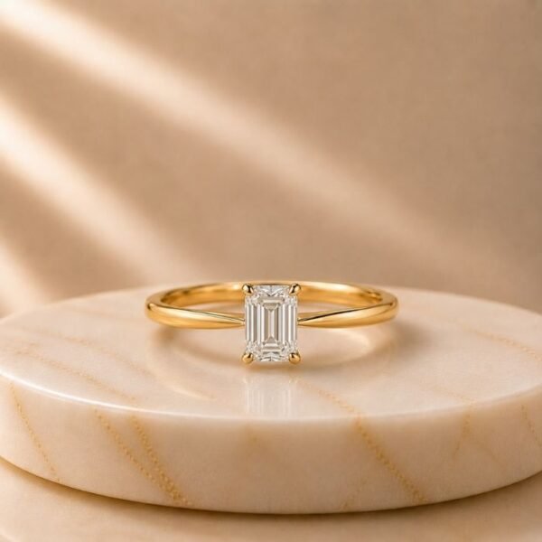 Emerald Cut Solitaire Yellow Gold Ring featuring a sleek emerald-cut lab-grown diamond set in a polished yellow gold band with timeless elegance.
