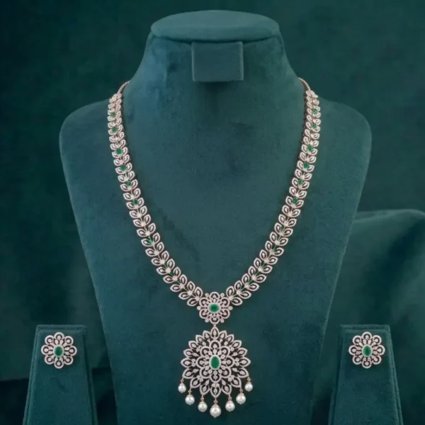 Stunning bridal necklace featuring deep emerald green gemstones and brilliant diamonds on a dark velvet display.