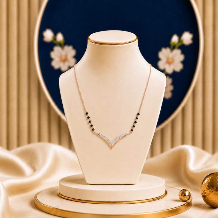 Fashionable Chevron Diamond Mangalsutra Fashionable Chevron Diamond Mangalsutra featuring a sleek chevron-inspired pendant adorned with sparkling lab-grown diamonds and elegant black bead chain detailing.