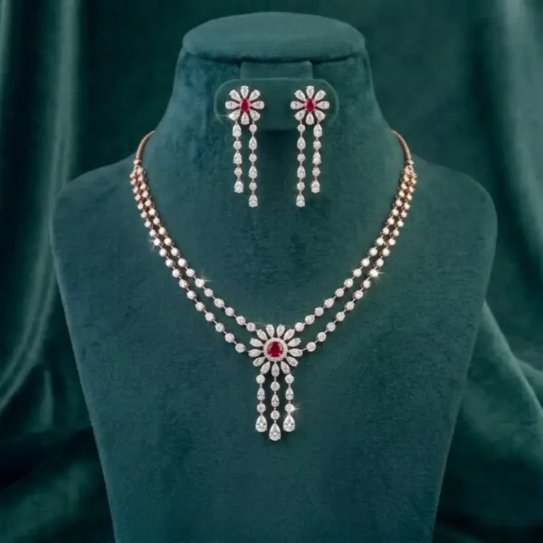 Elegant floral ruby and diamond drop necklace set displayed next to delicate baby's breath.