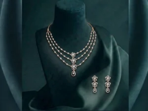 Elegant three-layer lab-grown CVD diamond necklace set with floral blossom motifs in a polished gold finish.