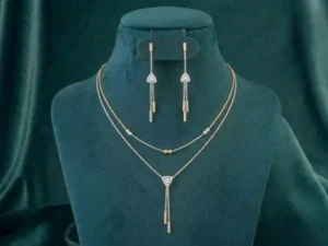 A two-strand layered diamond necklace set featuring a shimmering tassel pendant and round brilliant cut diamonds in a gold setting.