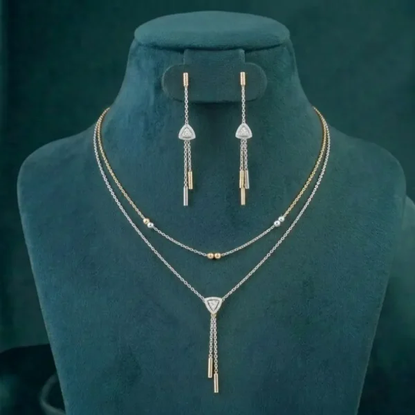A two-strand layered diamond necklace set featuring a shimmering tassel pendant and round brilliant cut diamonds in a gold setting.