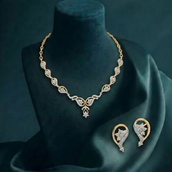 A high-end jewelry set showcasing a delicate leaf-motif necklace and earrings with shimmering pavé diamonds.