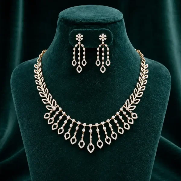 Stunning fringe-style necklace featuring delicate diamond-encrusted leaf motifs that drape elegantly on a velvet display.